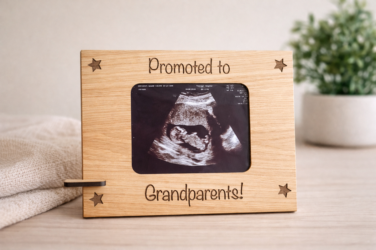 Personalised pregnancy announcement frame holding an ultrasound photo, engraved with “Promoted to Grandparents,” displayed on a wooden stand.
