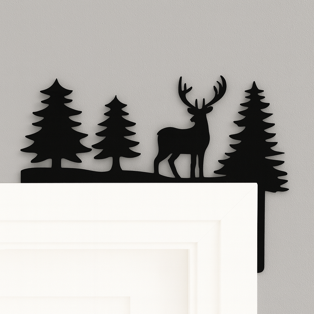 Decorative wall art with a deer and trees silhouette on a white surface.