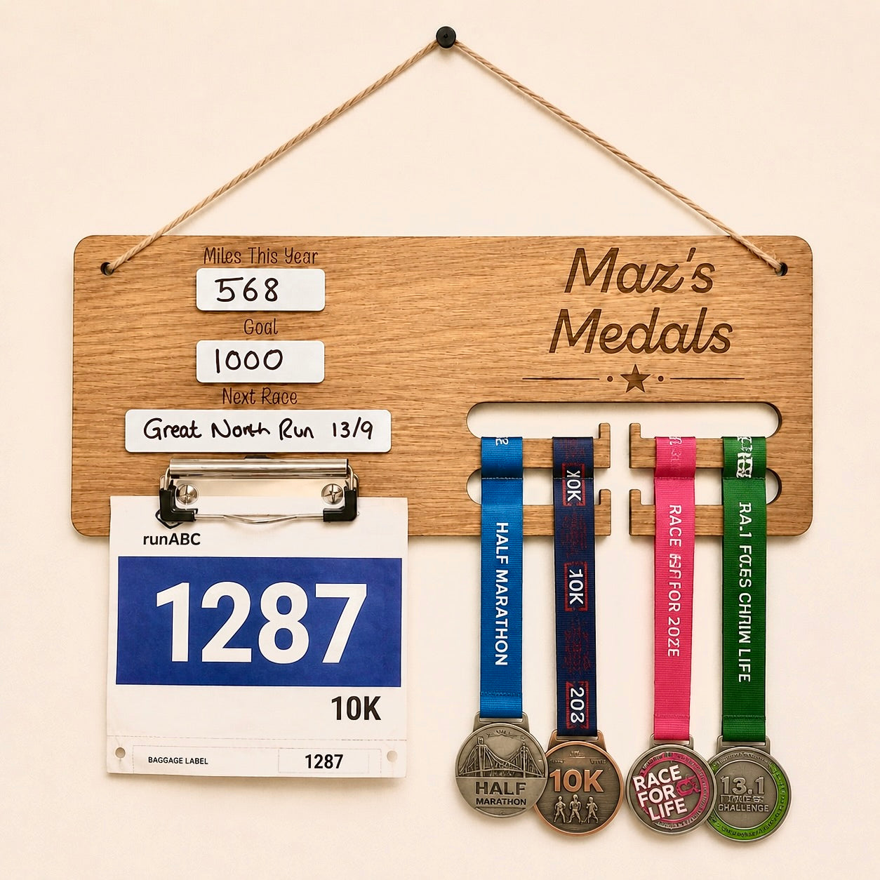 Personalised running medal holder with race bib clip, reusable dry wipe running tracker and engraved oak veneer medal display