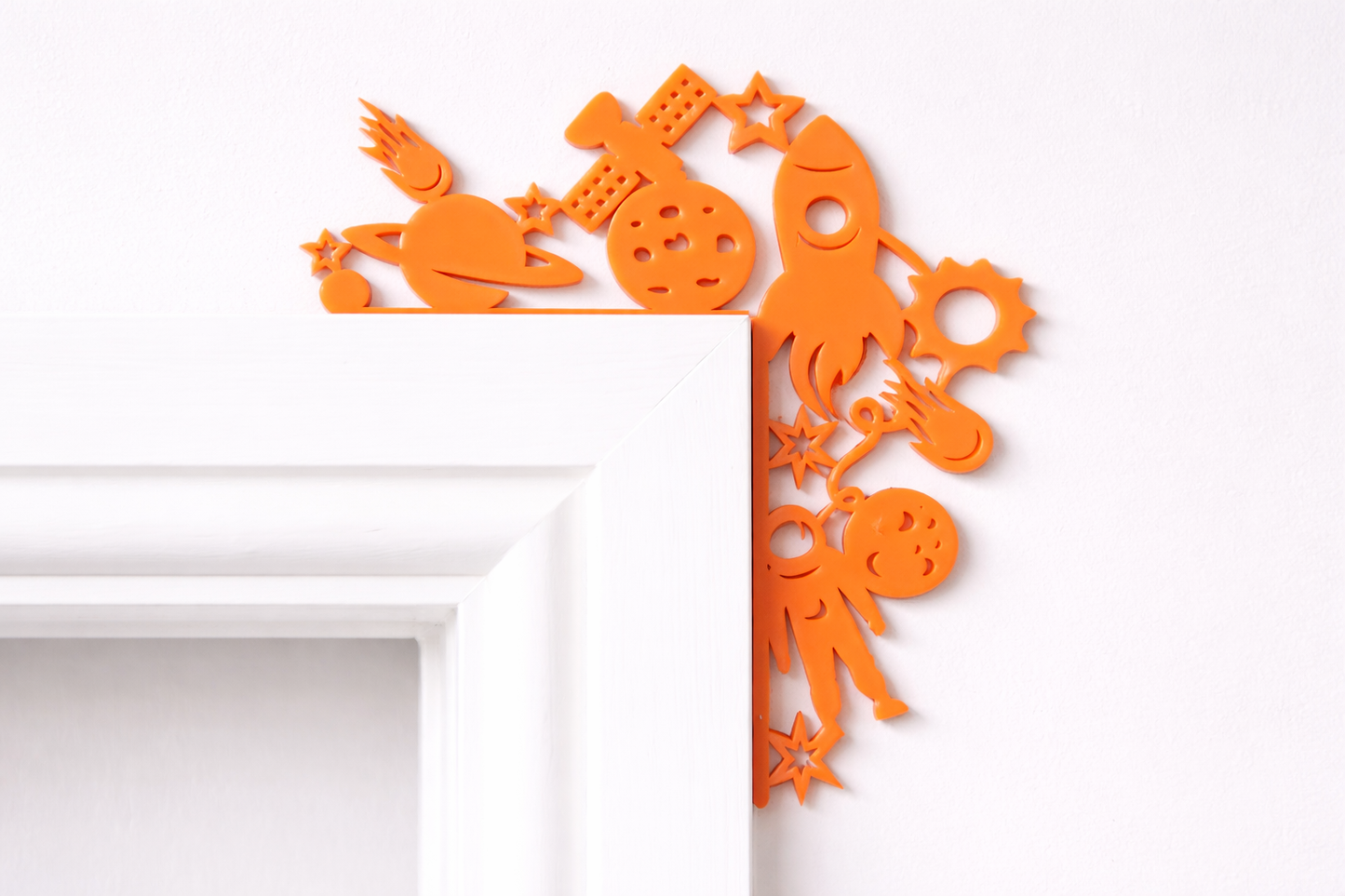 Rocket door corner decoration made from acrylic, displayed on a door frame in a child’s bedroom or playroom.
