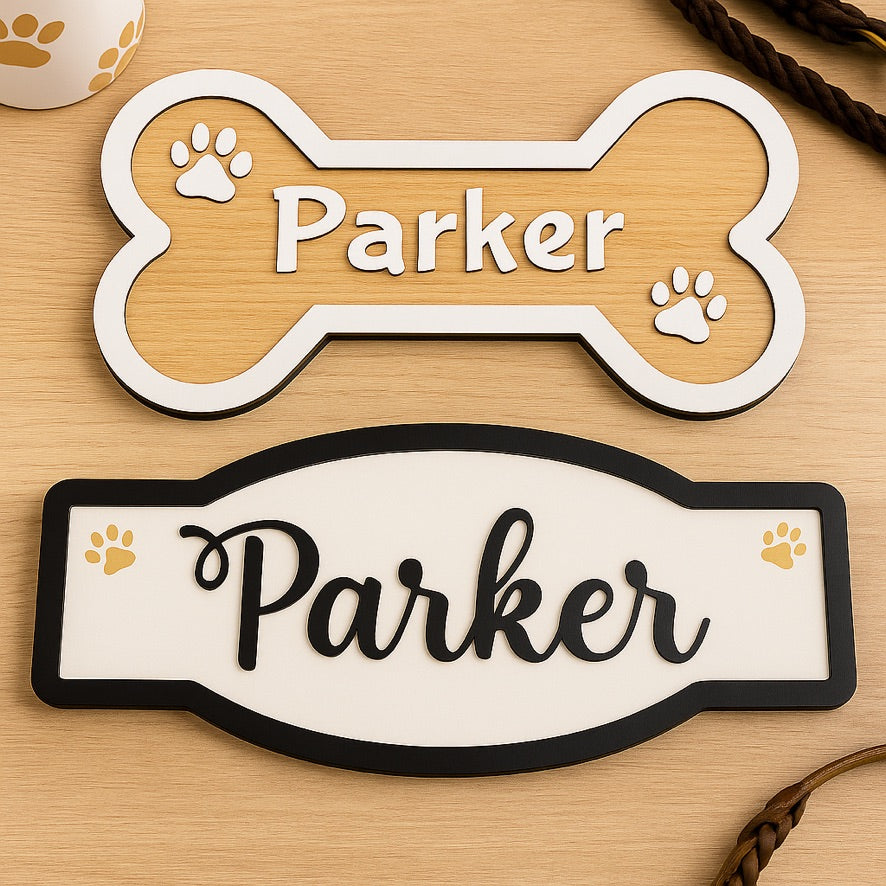 Two pet nameplates with 'Parker' on a wooden surface