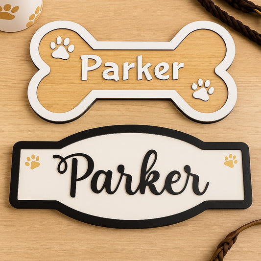 Two pet nameplates with 'Parker' on a wooden surface