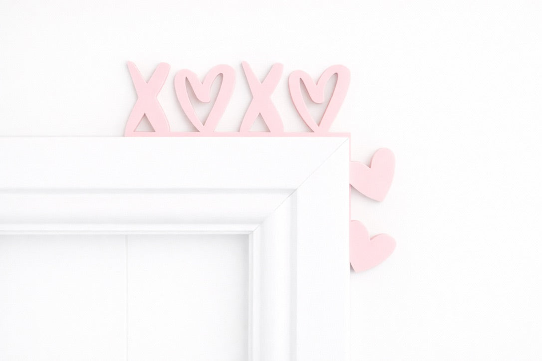 XOXO door corner decoration made from acrylic, displayed on a door frame as modern love-themed home decor.
