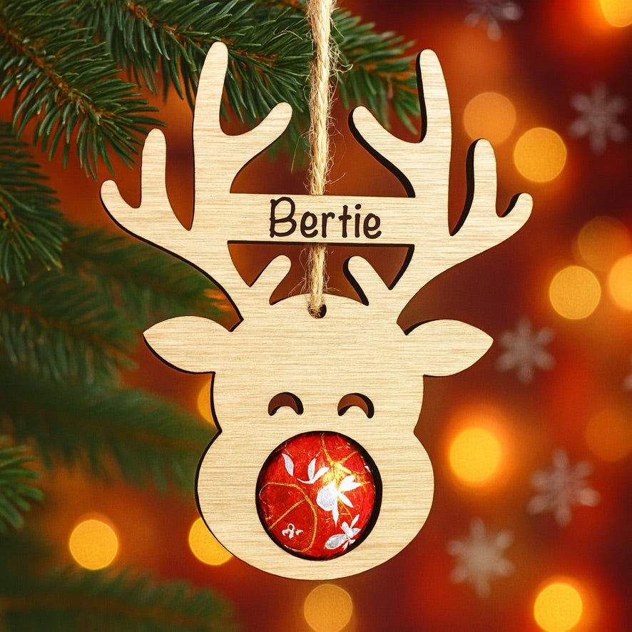Personalised wooden reindeer ornament made from oak veneer with engraved name on antlers and twine for hanging.