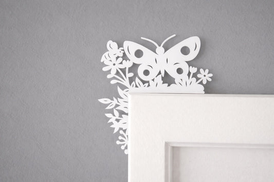 White butterfly and floral design on a gray wall